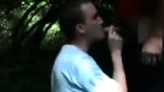 Twink blowing two guys in the woods by the highway