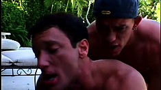 By the pool, two horny young guys exchange blowjobs and engage in anal sex
