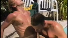 Well built dudes get into the pool and blow each other in hot gay clip